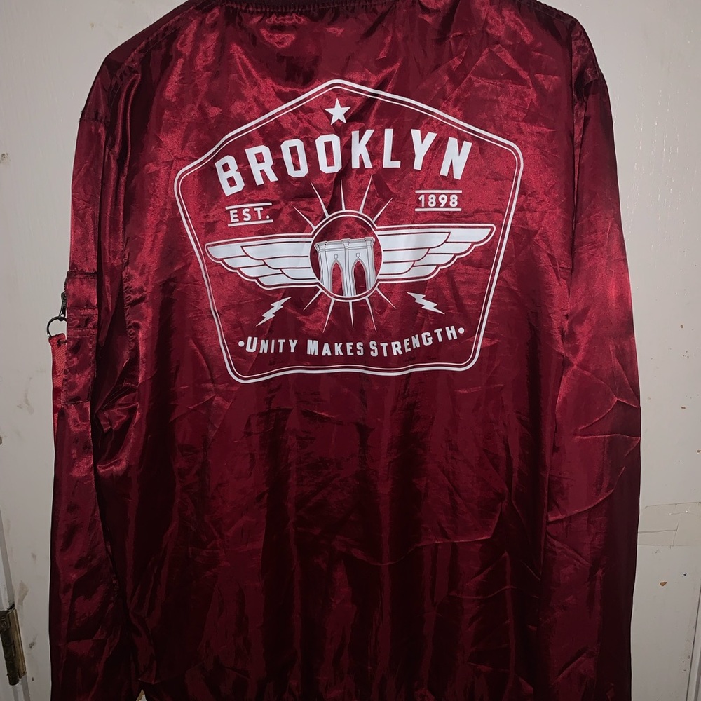 Maroon bomber jacket Brooklyn unity makes strength